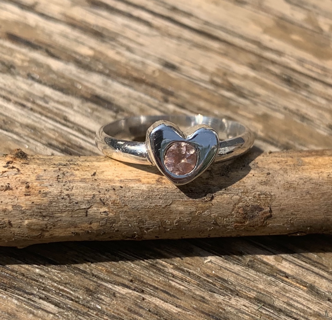 Ring with a heart-shaped stone in a sculptural setting
