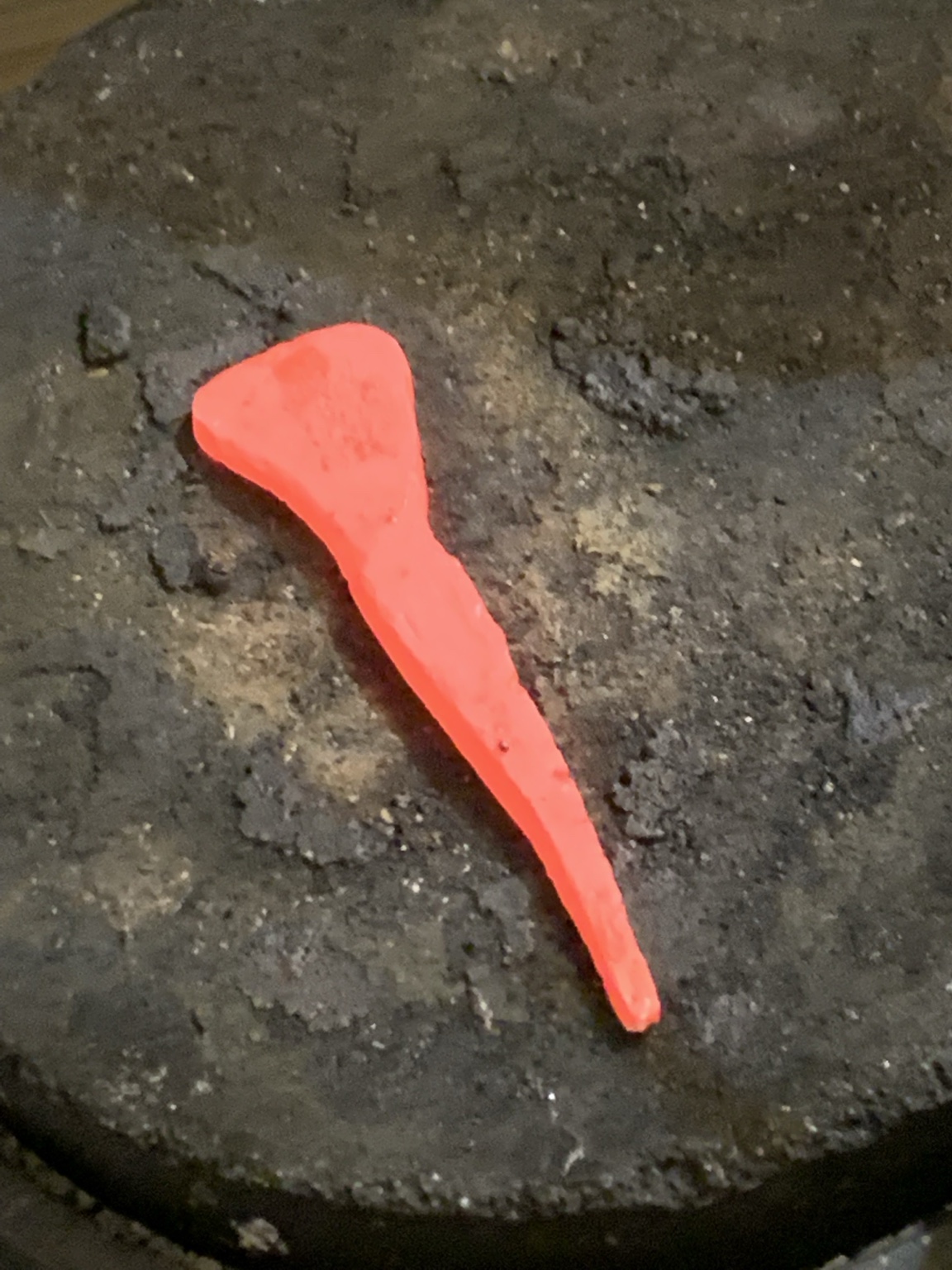 Metal element heated red during forging