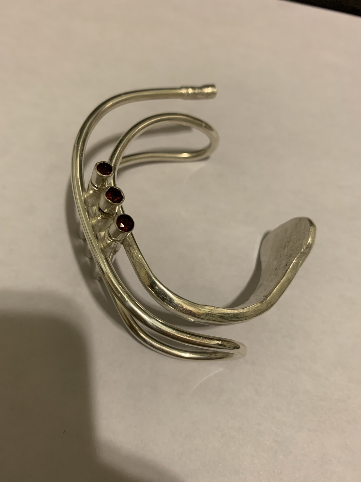 The same trumpet cuff from another angle, showing its curved construction