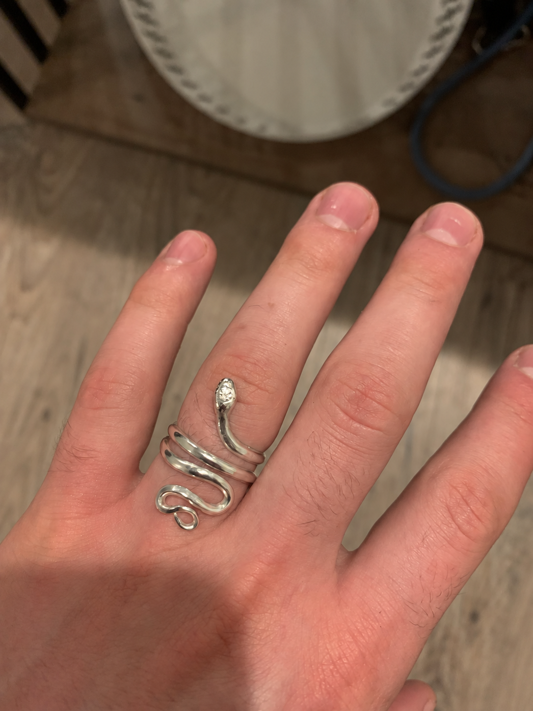 Snake-shaped ring coiled around a finger